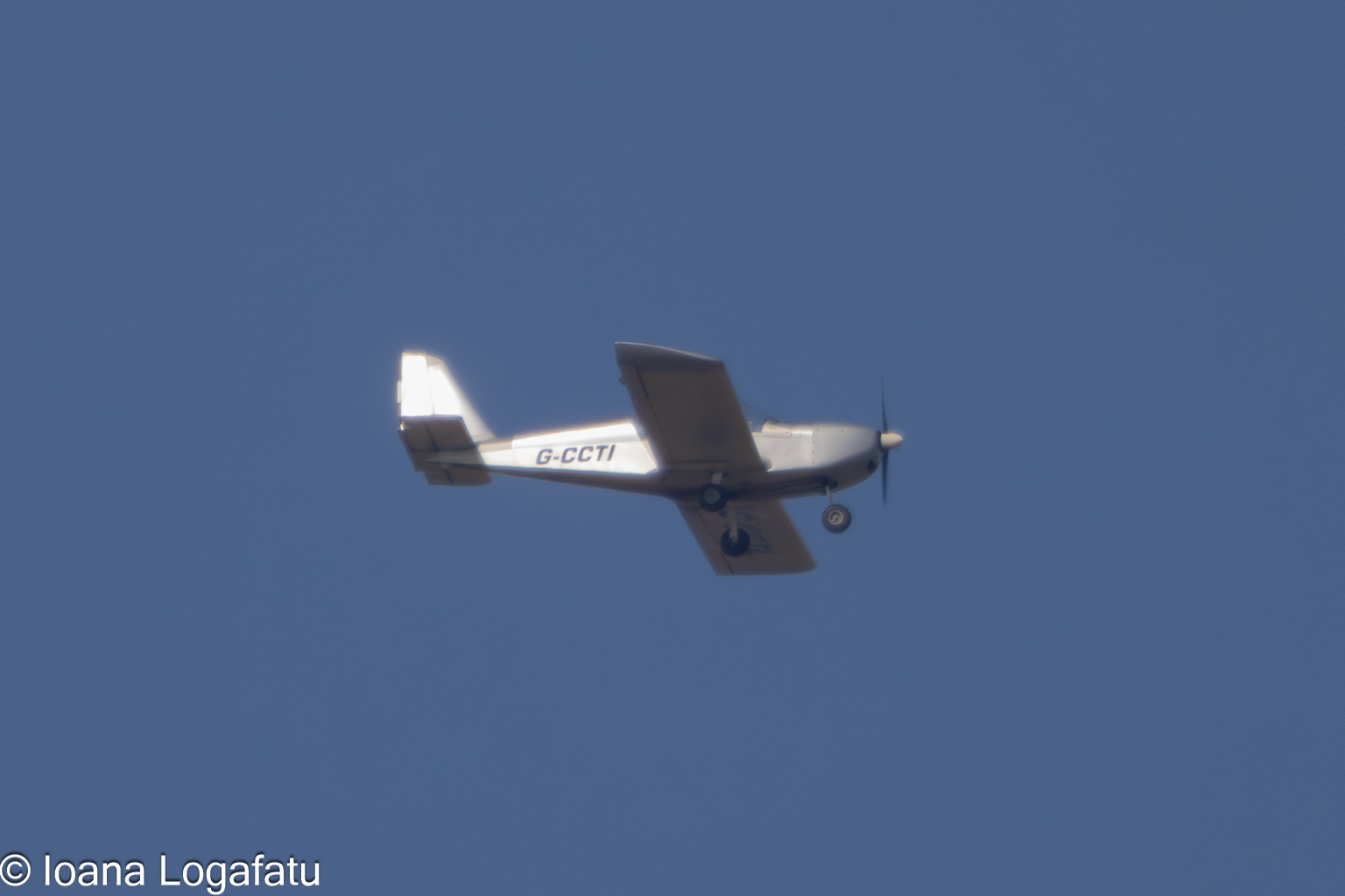 Small aircraft soars gracefully in clear skies